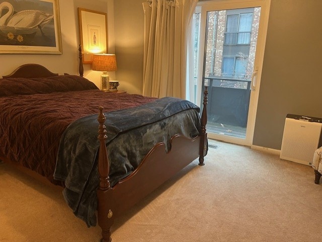 carpeted bedroom with access to outside