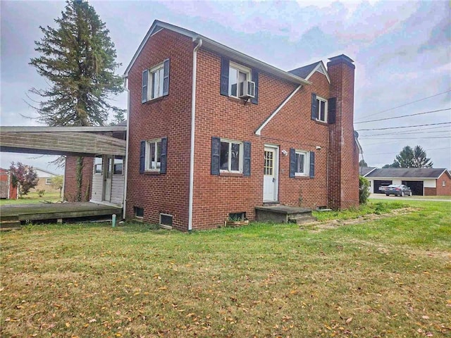 115 Mountain View Dr, E/W Wheatfield Twp, PA 15920 - view of home's exterior featuring brick siding, a yard, cooling unit, and a chimney
