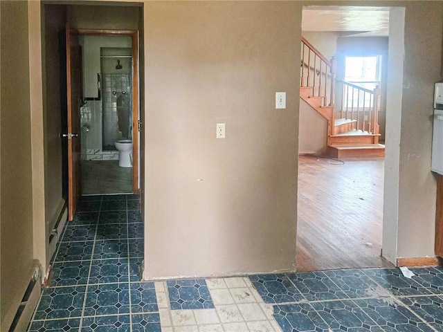 115 Mountain View Dr, E/W Wheatfield Twp, PA 15920 - hallway featuring stairway, a baseboard heating unit, and tile patterned floors