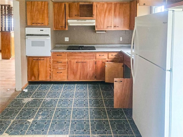 115 Mountain View Dr, E/W Wheatfield Twp, PA 15920 - kitchen with white appliances, under cabinet range hood, dark floors, and light countertops