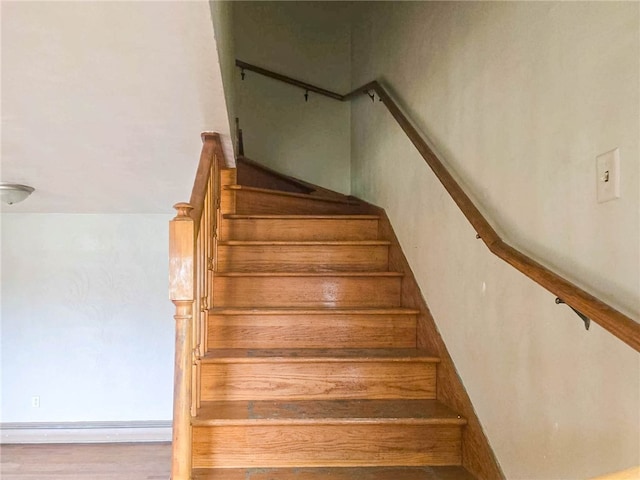 stairs featuring wood-type flooring