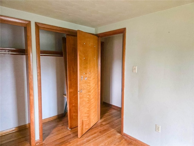 unfurnished bedroom featuring hardwood / wood-style floors