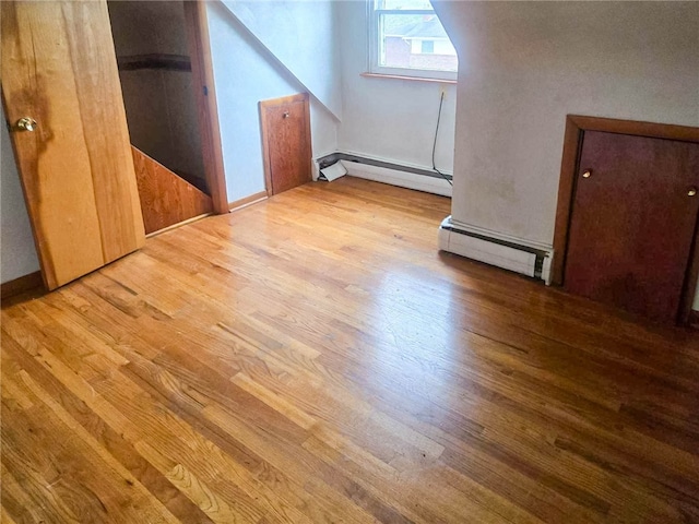 interior space featuring light wood-type flooring and a baseboard heating unit