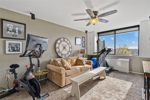 carpeted living room with ceiling fan