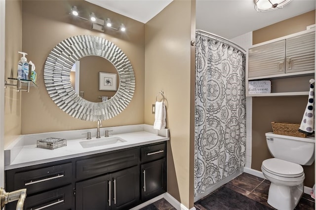 bathroom with tile patterned flooring, vanity, and toilet