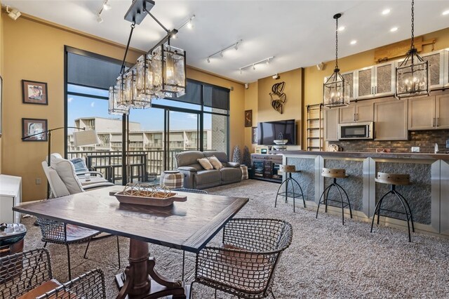 carpeted dining room featuring ornamental molding