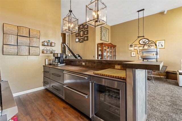 bar with butcher block countertops, decorative light fixtures, dark wood-type flooring, and wine cooler