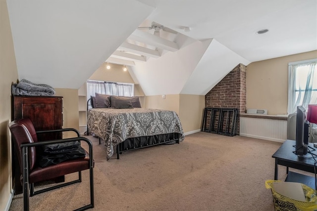 bedroom with lofted ceiling with beams and light colored carpet