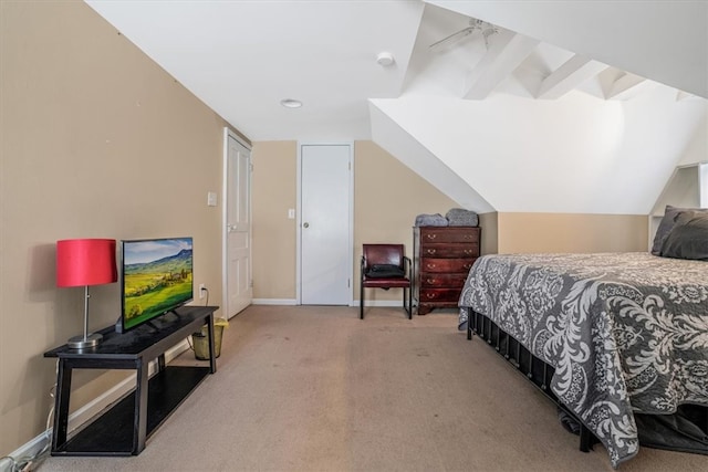 carpeted bedroom featuring vaulted ceiling