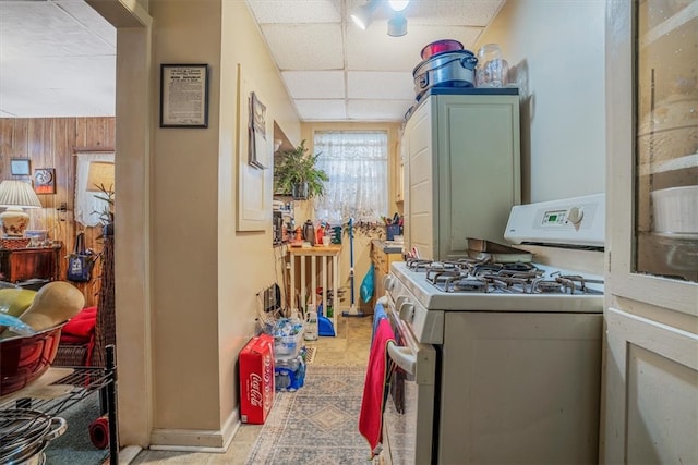 kitchen featuring a drop ceiling and white range with gas cooktop