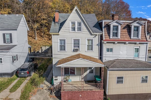 view of front of house with a porch and cooling unit