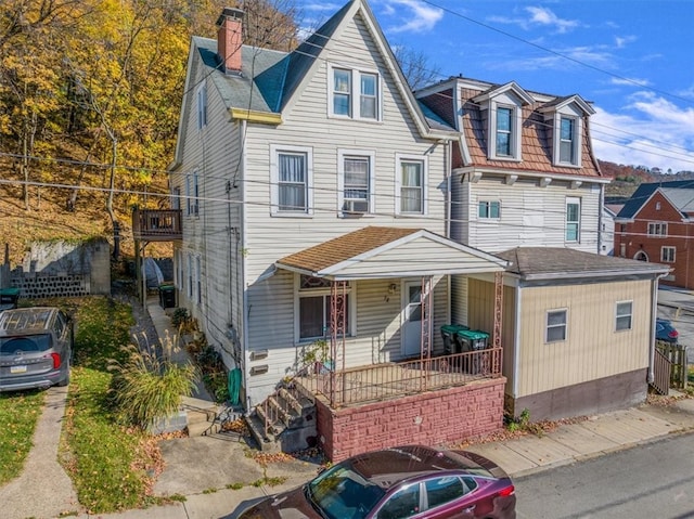 view of front of house featuring covered porch and cooling unit