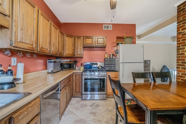 kitchen featuring sink, ceiling fan, and stainless steel appliances