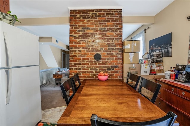 dining area featuring light carpet