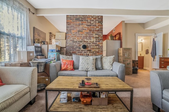 carpeted living room featuring beamed ceiling