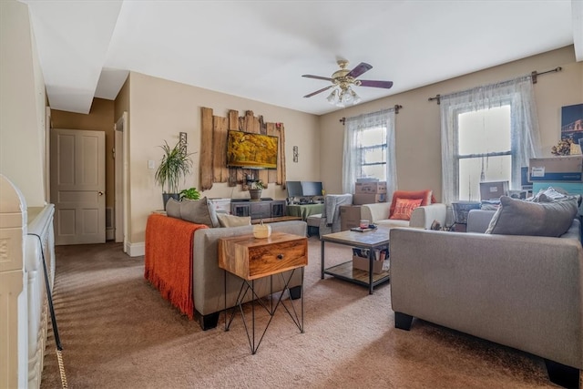 carpeted living room with ceiling fan