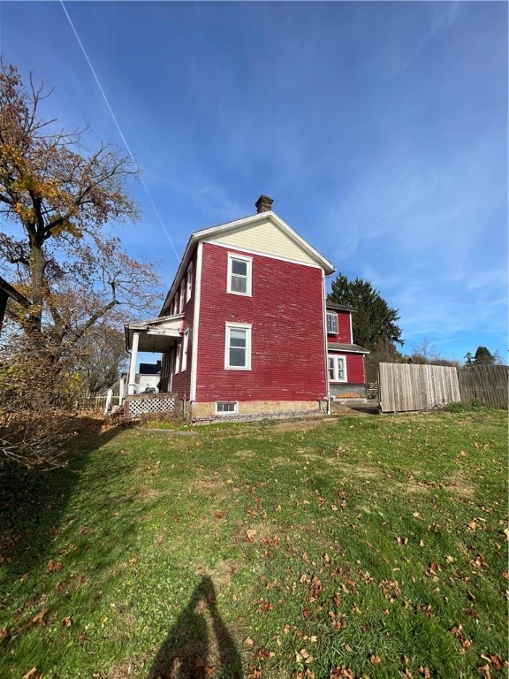 view of side of property with a lawn