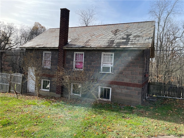 view of property exterior with a lawn