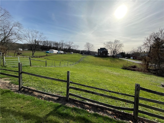 view of gate featuring a rural view and a yard