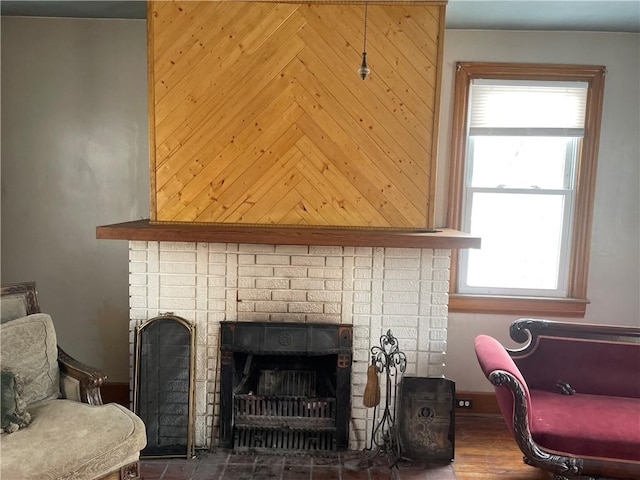 living area featuring a healthy amount of sunlight and a brick fireplace