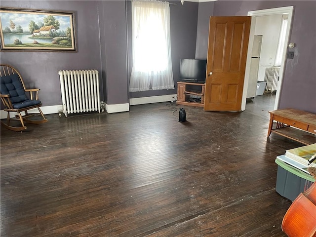 sitting room featuring dark hardwood / wood-style flooring and radiator heating unit