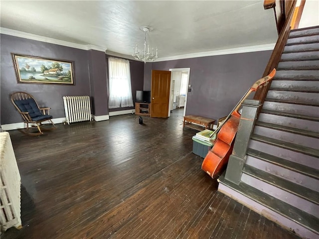 unfurnished room with dark hardwood / wood-style floors, radiator heating unit, crown molding, and a chandelier