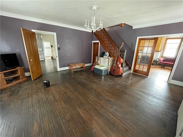 unfurnished living room with dark hardwood / wood-style flooring, french doors, crown molding, and a chandelier