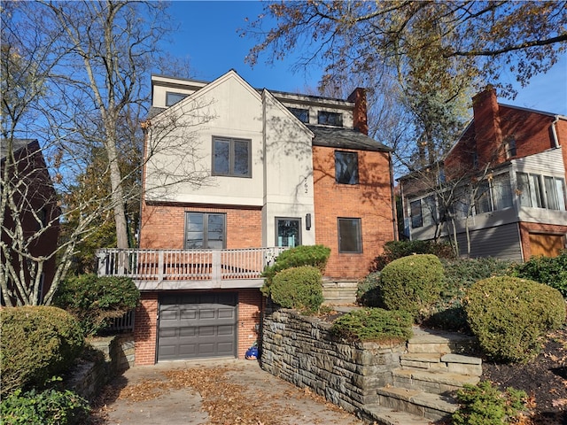 view of front of home with a garage and a balcony