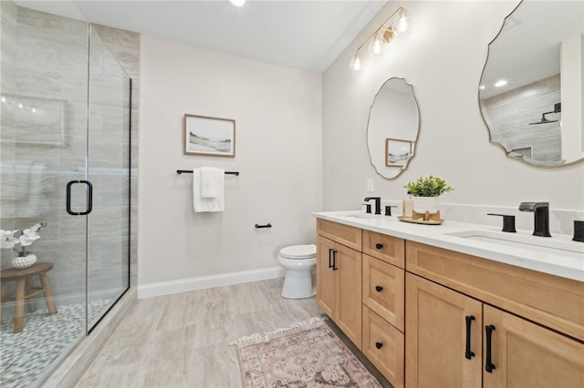 bathroom with hardwood / wood-style flooring, vanity, toilet, and walk in shower