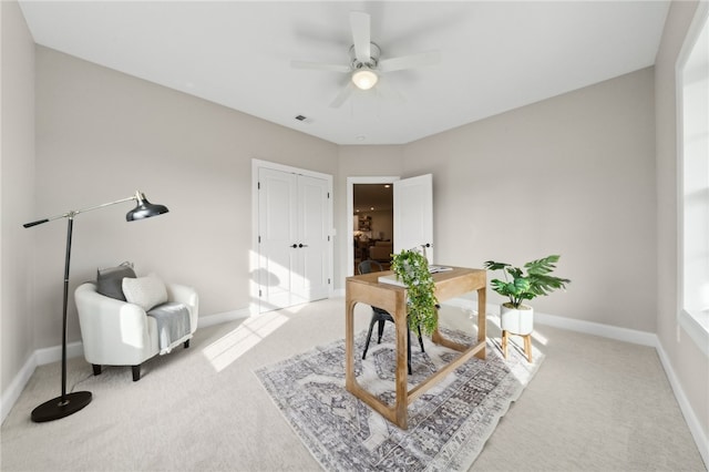 carpeted office with ceiling fan