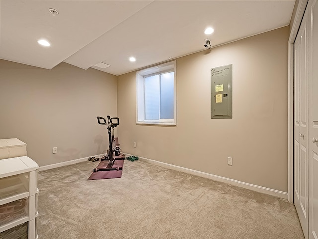 workout room with light carpet and electric panel