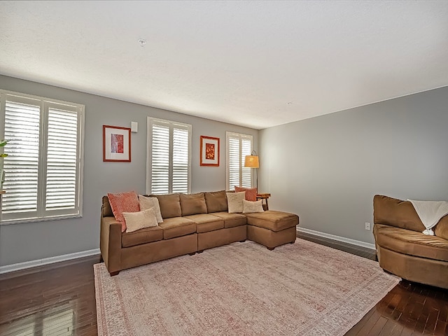 living room with a healthy amount of sunlight and dark hardwood / wood-style floors