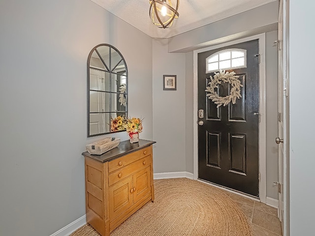 tiled foyer entrance featuring a textured ceiling