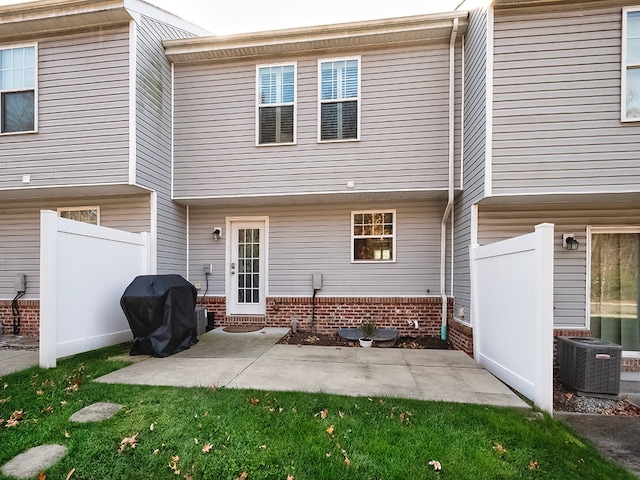 rear view of house with a patio and central AC unit