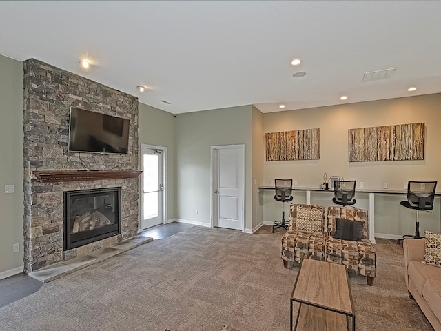 living room with a fireplace and carpet floors