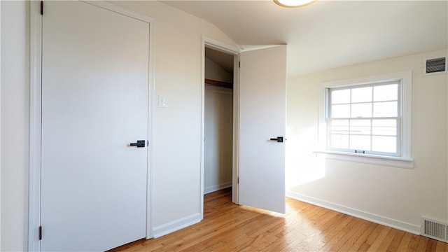 unfurnished bedroom featuring a closet and light wood-type flooring