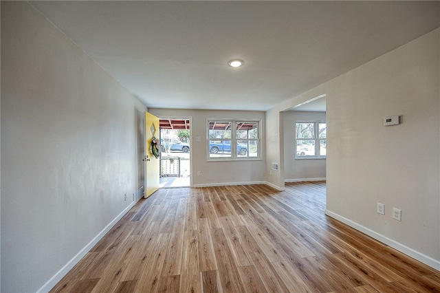 unfurnished living room with plenty of natural light and light hardwood / wood-style floors