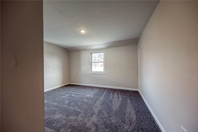 empty room featuring dark carpet