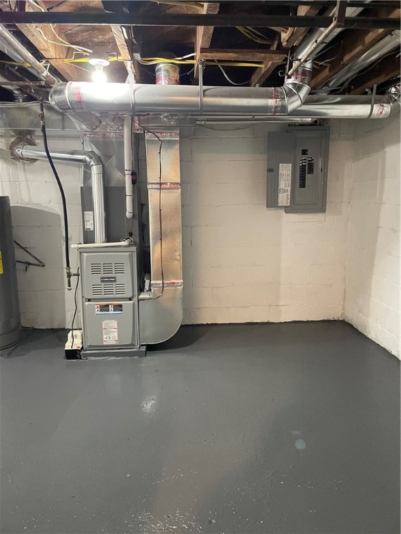 basement featuring heating unit, electric panel, and water heater