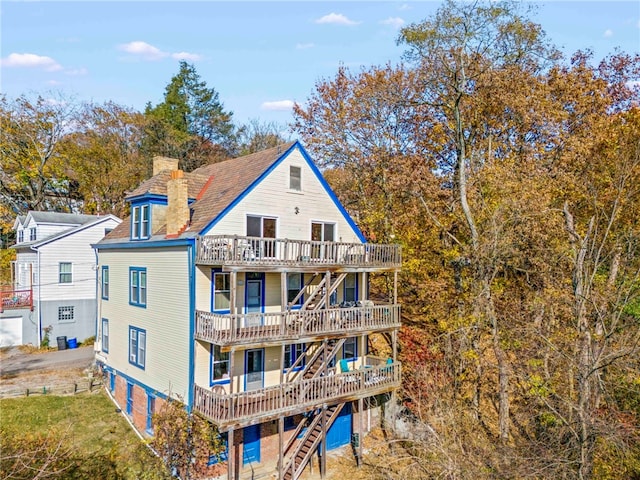 rear view of property featuring a deck