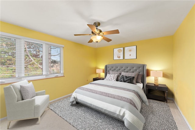 bedroom featuring ceiling fan and light carpet