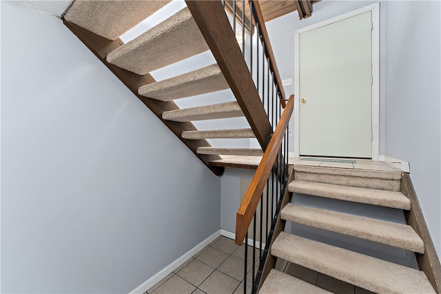 staircase featuring tile patterned floors