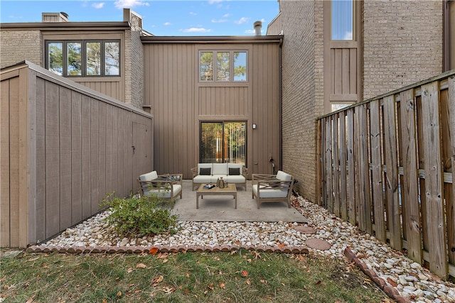 back of house featuring outdoor lounge area and a patio area