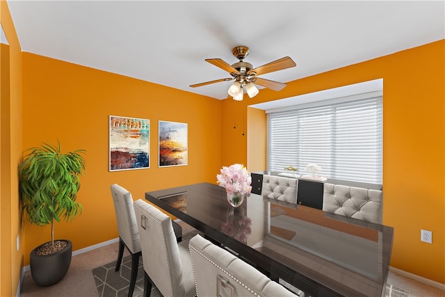 dining area with ceiling fan and carpet floors