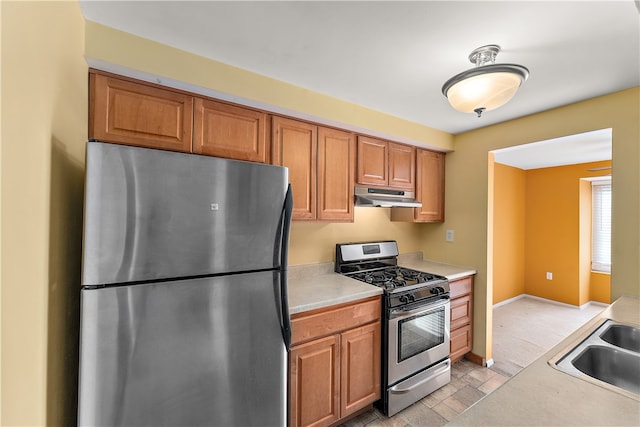 kitchen with light carpet, sink, and stainless steel appliances