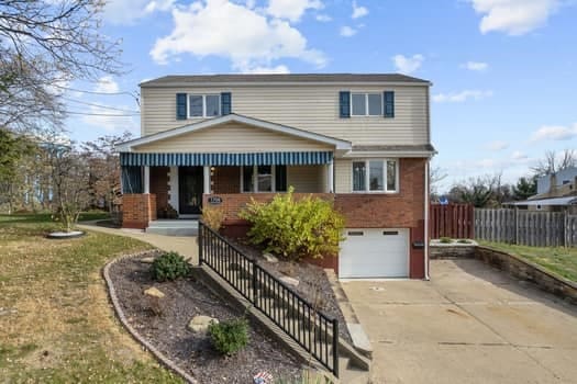 front of property with a garage and a front yard