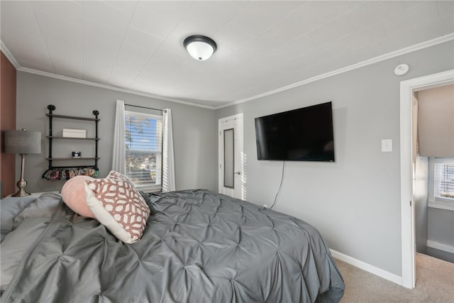 bedroom with carpet floors, multiple windows, and ornamental molding