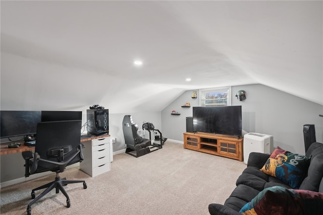 carpeted home office featuring lofted ceiling