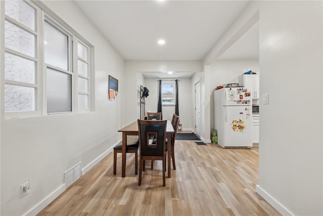 dining area with light wood-type flooring