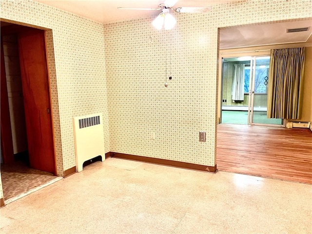 unfurnished room featuring ceiling fan, baseboard heating, and radiator